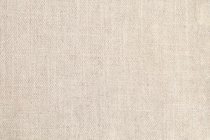Natural Linen Material Textile Canvas Fabric Texture Background Close-up Detail of Fabric Natural Color Hemp Material Pattern Design Wallpaper. Can be Used as Background or For Graphic Design photo