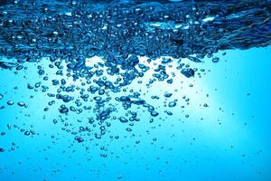 Fresh Water With Underwater Bubbles Texture on a Blue Background Close-up Abstract Liquid Bubbles Aqua Design Wallpaper photo