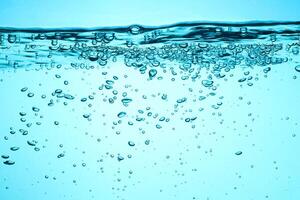 Fresh Water With Underwater Bubbles Texture on a Blue Background Close-up Abstract Liquid Bubbles Aqua Design Wallpaper photo