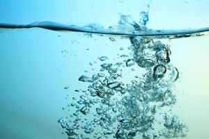 Fresh Water With Underwater Bubbles Texture on a Blue Background Close-up Abstract Liquid Bubbles Aqua Design Wallpaper photo