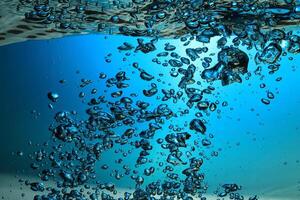 Fresh Water With Underwater Bubbles Texture on a Blue Background Close-up Abstract Liquid Bubbles Aqua Design Wallpaper photo