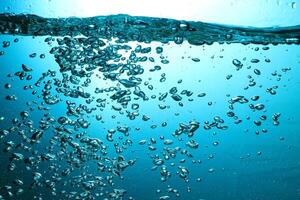 Fresh Water With Underwater Bubbles Texture on a Blue Background Close-up Abstract Liquid Bubbles Aqua Design Wallpaper photo