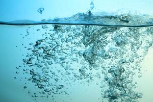 Fresh Water With Underwater Bubbles Texture on a Blue Background Close-up Abstract Liquid Bubbles Aqua Design Wallpaper photo