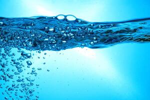 Fresh Water With Underwater Bubbles Texture on a Blue Background Close-up Abstract Liquid Bubbles Aqua Design Wallpaper photo