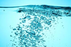 Fresh Water With Underwater Bubbles Texture on a Blue Background Close-up Abstract Liquid Bubbles Aqua Design Wallpaper photo