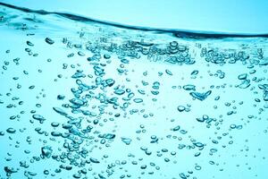 Fresh Water With Underwater Bubbles Texture on a Blue Background Close-up Abstract Liquid Bubbles Aqua Design Wallpaper photo