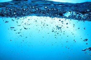 Fresh Water With Underwater Bubbles Texture on a Blue Background Close-up Abstract Liquid Bubbles Aqua Design Wallpaper photo