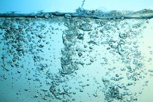 Fresh Water With Underwater Bubbles Texture on a Blue Background Close-up Abstract Liquid Bubbles Aqua Design Wallpaper photo