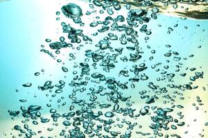 Fresh Water With Underwater Bubbles Texture on a Blue Background Close-up Abstract Liquid Bubbles Aqua Design Wallpaper photo