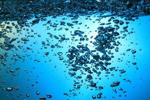 Fresh Water With Underwater Bubbles Texture on a Blue Background Close-up Abstract Liquid Bubbles Aqua Design Wallpaper photo