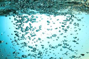 Fresh Water With Underwater Bubbles Texture on a Blue Background Close-up Abstract Liquid Bubbles Aqua Design Wallpaper photo