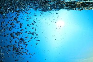 Fresh Water With Underwater Bubbles Texture on a Blue Background Close-up Abstract Liquid Bubbles Aqua Design Wallpaper photo