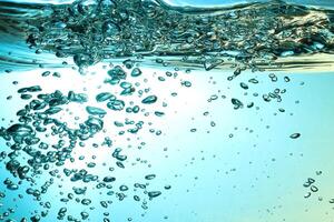 Fresh Water With Underwater Bubbles Texture on a Blue Background Close-up Abstract Liquid Bubbles Aqua Design Wallpaper photo