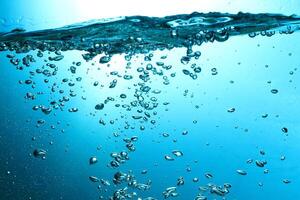Fresh Water With Underwater Bubbles Texture on a Blue Background Close-up Abstract Liquid Bubbles Aqua Design Wallpaper photo