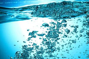 Fresh Water With Underwater Bubbles Texture on a Blue Background Close-up Abstract Liquid Bubbles Aqua Design Wallpaper photo