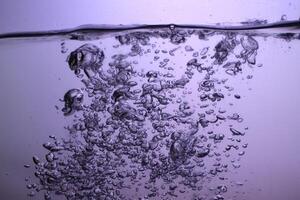 Fresh Water With Underwater Bubbles Texture on a Blue Background Close-up Abstract Liquid Bubbles Aqua Design Wallpaper photo