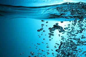 Fresh Water With Underwater Bubbles Texture on a Blue Background Close-up Abstract Liquid Bubbles Aqua Design Wallpaper photo