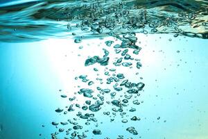 Fresh Water With Underwater Bubbles Texture on a Blue Background Close-up Abstract Liquid Bubbles Aqua Design Wallpaper photo