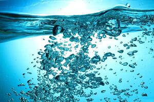 Fresh Water With Underwater Bubbles Texture on a Blue Background Close-up Abstract Liquid Bubbles Aqua Design Wallpaper photo
