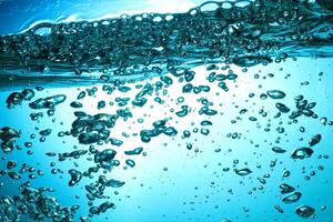 Fresh Water With Underwater Bubbles Texture on a Blue Background Close-up Abstract Liquid Bubbles Aqua Design Wallpaper photo
