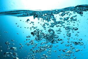 Fresh Water With Underwater Bubbles Texture on a Blue Background Close-up Abstract Liquid Bubbles Aqua Design Wallpaper photo