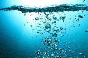 Fresh Water With Underwater Bubbles Texture on a Blue Background Close-up Abstract Liquid Bubbles Aqua Design Wallpaper photo