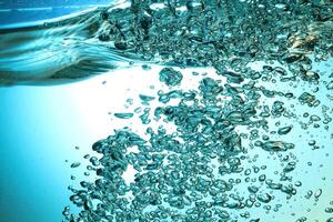 Fresh Water With Underwater Bubbles Texture on a Blue Background Close-up Abstract Liquid Bubbles Aqua Design Wallpaper photo