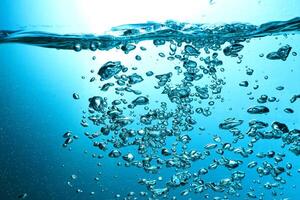 Fresh Water With Underwater Bubbles Texture on a Blue Background Close-up Abstract Liquid Bubbles Aqua Design Wallpaper photo