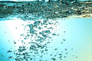 Fresh Water With Underwater Bubbles Texture on a Blue Background Close-up Abstract Liquid Bubbles Aqua Design Wallpaper photo