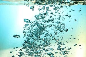 Fresh Water With Underwater Bubbles Texture on a Blue Background Close-up Abstract Liquid Bubbles Aqua Design Wallpaper photo