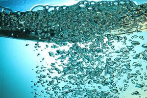 Fresh Water With Underwater Bubbles Texture on a Blue Background Close-up Abstract Liquid Bubbles Aqua Design Wallpaper photo