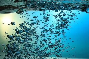 Fresh Water With Underwater Bubbles Texture on a Blue Background Close-up Abstract Liquid Bubbles Aqua Design Wallpaper photo