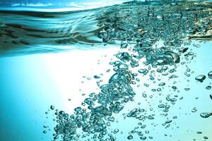 Fresh Water With Underwater Bubbles Texture on a Blue Background Close-up Abstract Liquid Bubbles Aqua Design Wallpaper photo