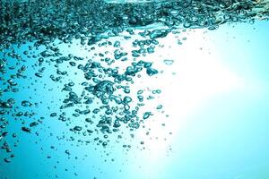 Fresh Water With Underwater Bubbles Texture on a Blue Background Close-up Abstract Liquid Bubbles Aqua Design Wallpaper photo