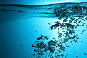 Fresh Water With Underwater Bubbles Texture on a Blue Background Close-up Abstract Liquid Bubbles Aqua Design Wallpaper photo