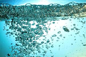 Fresh Water With Underwater Bubbles Texture on a Blue Background Close-up Abstract Liquid Bubbles Aqua Design Wallpaper photo