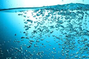 Fresh Water With Underwater Bubbles Texture on a Blue Background Close-up Abstract Liquid Bubbles Aqua Design Wallpaper photo