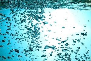 Fresh Water With Underwater Bubbles Texture on a Blue Background Close-up Abstract Liquid Bubbles Aqua Design Wallpaper photo