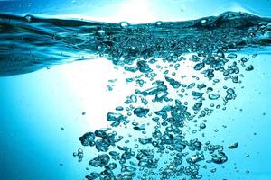 Fresh Water With Underwater Bubbles Texture on a Blue Background Close-up Abstract Liquid Bubbles Aqua Design Wallpaper photo
