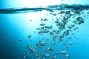 Fresh Water With Underwater Bubbles Texture on a Blue Background Close-up Abstract Liquid Bubbles Aqua Design Wallpaper photo