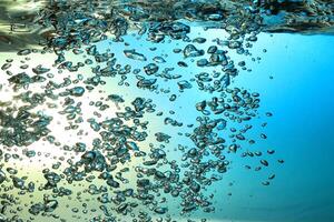 Fresh Water With Underwater Bubbles Texture on a Blue Background Close-up Abstract Liquid Bubbles Aqua Design Wallpaper photo