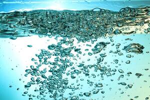 Fresh Water With Underwater Bubbles Texture on a Blue Background Close-up Abstract Liquid Bubbles Aqua Design Wallpaper photo