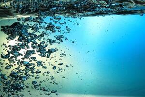 Fresh Water With Underwater Bubbles Texture on a Blue Background Close-up Abstract Liquid Bubbles Aqua Design Wallpaper photo