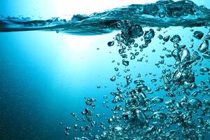 Fresh Water With Underwater Bubbles Texture on a Blue Background Close-up Abstract Liquid Bubbles Aqua Design Wallpaper photo