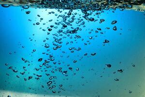 Fresh Water With Underwater Bubbles Texture on a Blue Background Close-up Abstract Liquid Bubbles Aqua Design Wallpaper photo