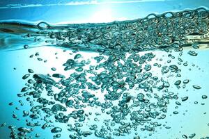 Fresh Water With Underwater Bubbles Texture on a Blue Background Close-up Abstract Liquid Bubbles Aqua Design Wallpaper photo