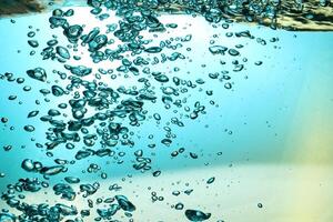 Fresh Water With Underwater Bubbles Texture on a Blue Background Close-up Abstract Liquid Bubbles Aqua Design Wallpaper photo