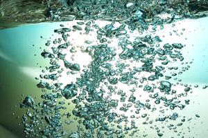 Fresh Water With Underwater Bubbles Texture on a Blue Background Close-up Abstract Liquid Bubbles Aqua Design Wallpaper photo