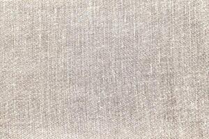 Natural Linen Material Textile Canvas Fabric Texture Background Close-up Detail of Fabric Natural Color Hemp Material Pattern Design Wallpaper. Can be Used as Background or For Graphic Design photo