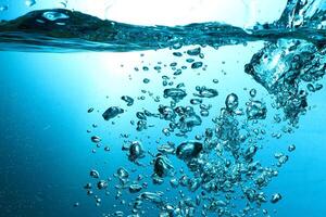 Fresh Water With Underwater Bubbles Texture on a Blue Background Close-up Abstract Liquid Bubbles Aqua Design Wallpaper photo